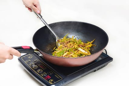 Induction vs Gas Stove electric cooktop heating a steel pan