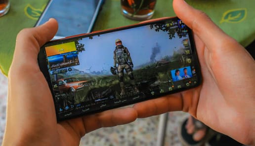 Teen playing mobile games for long hours showing signs of Phone Addiction and digital distraction