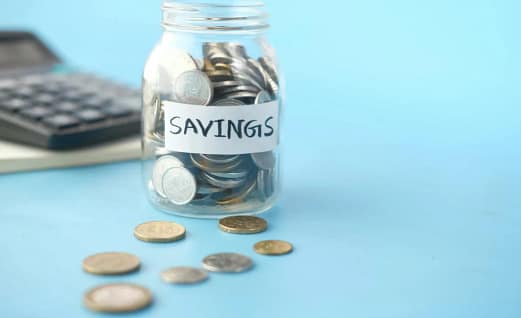 Person writing budgeting notes while planning Saving Money goals