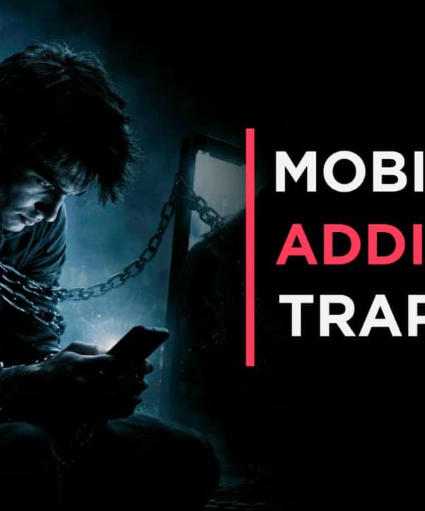 Man sitting in dark room using smartphone at night showing signs of Phone Addiction