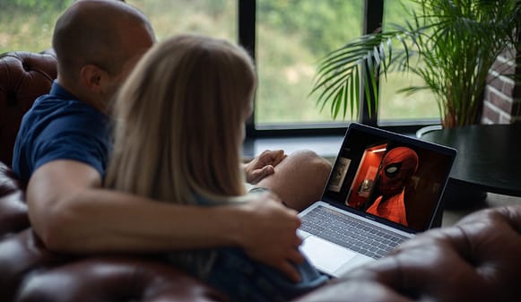 Person watching movies on OTT streaming platform on television at home